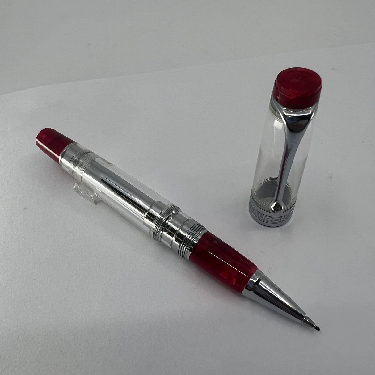 Aurora Optima Transparent Demonstrator Limited Edition Rollerball with Red Auroroloid Highlights